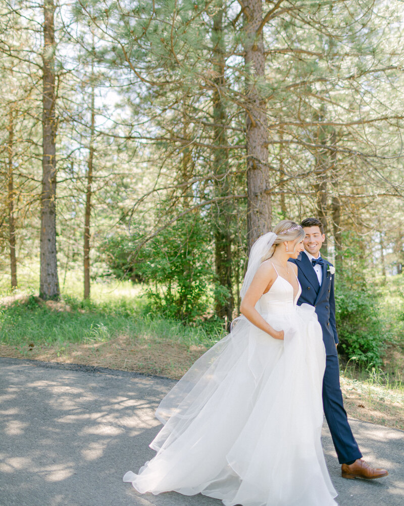 bride and groom holding hands and walking away at Swiftwater Cellars in Suncadia