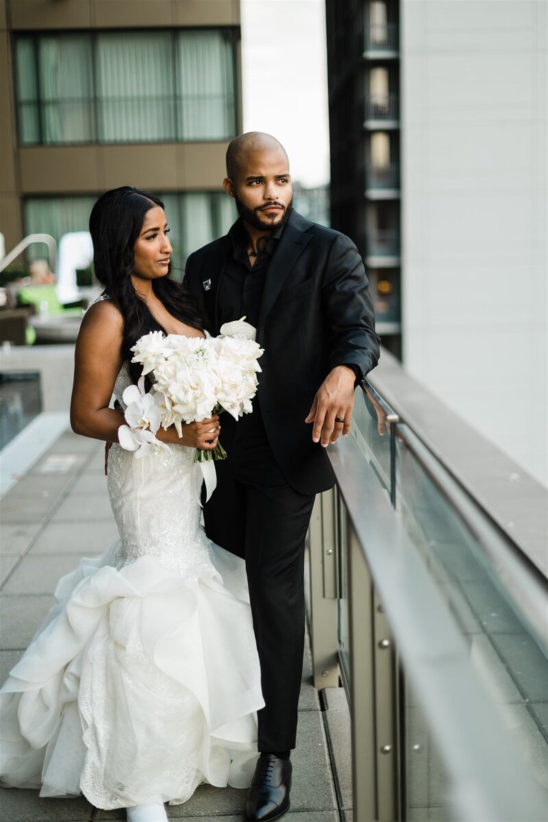black wedding couple poses on rooftop near seattle waterfront
