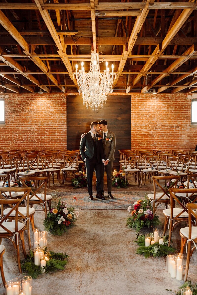 LGBTQ wedding ceremony held at the St Vrain with exposed brick and chandeliers