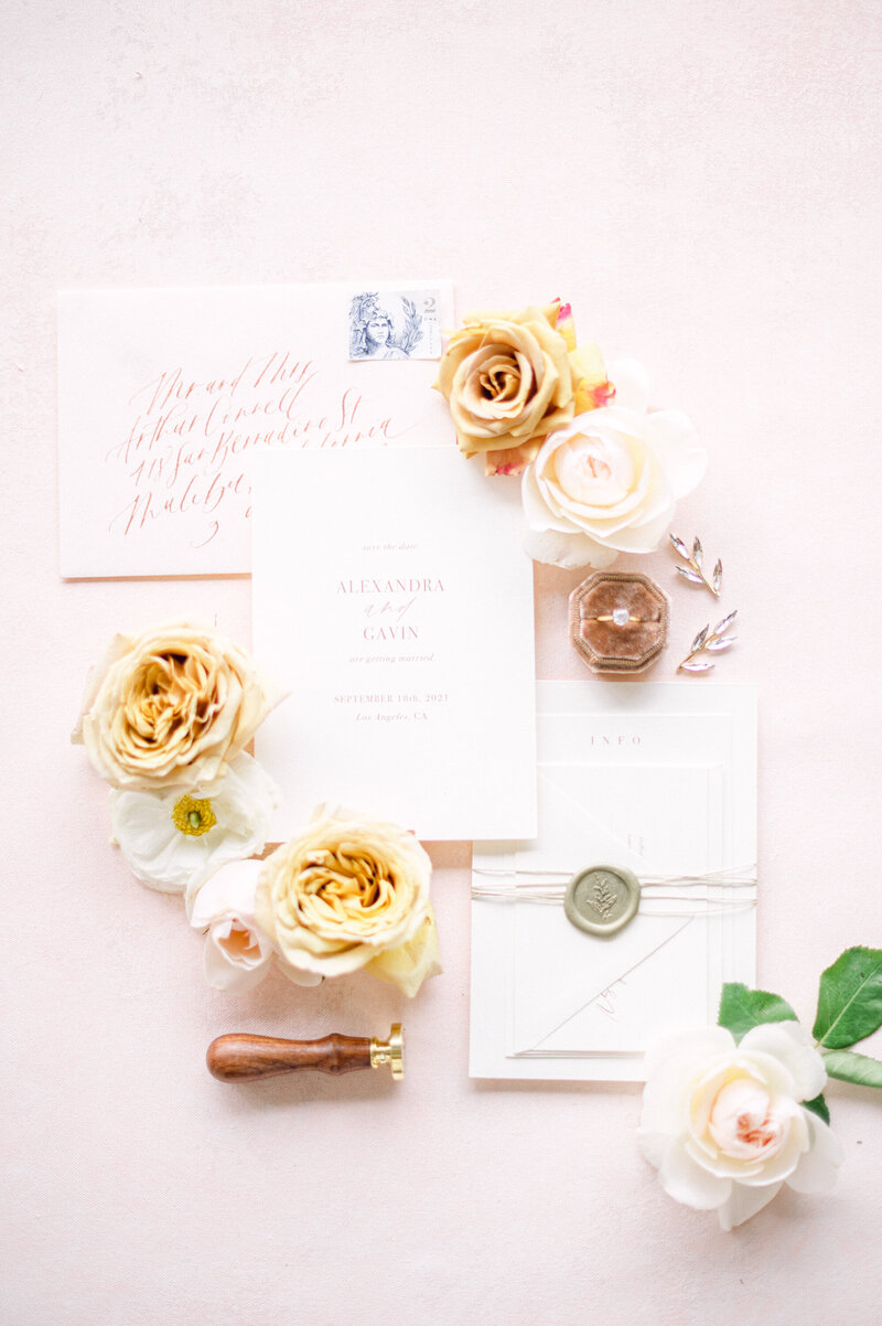 Small bloom additions to wedding invitations