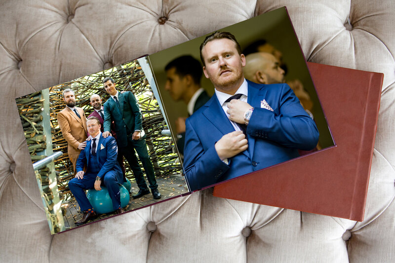 A wedding album with two images including a group portraits of groomsmen. The men are wearing fall colors suits in a garden.
