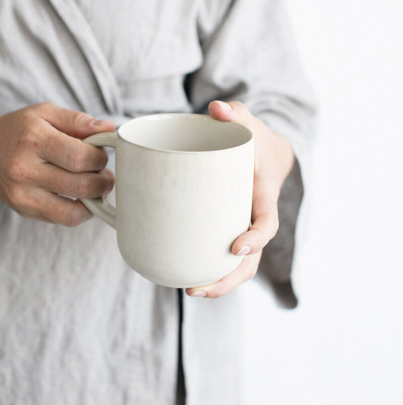 Hands holding a coffee cup