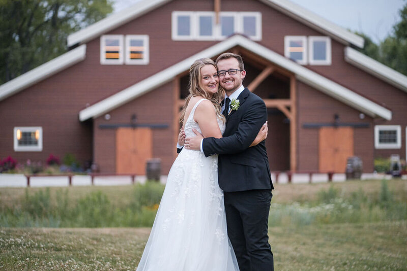 bride and groom hugging each other at barnwood events, a wedding venue in madison, winconsin.