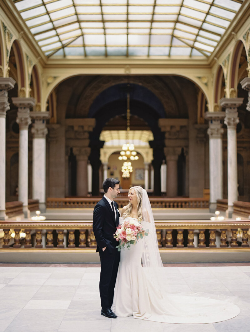 Bride and groom embracing under skylight photographed by Chicago wedding photographer Arielle Peters