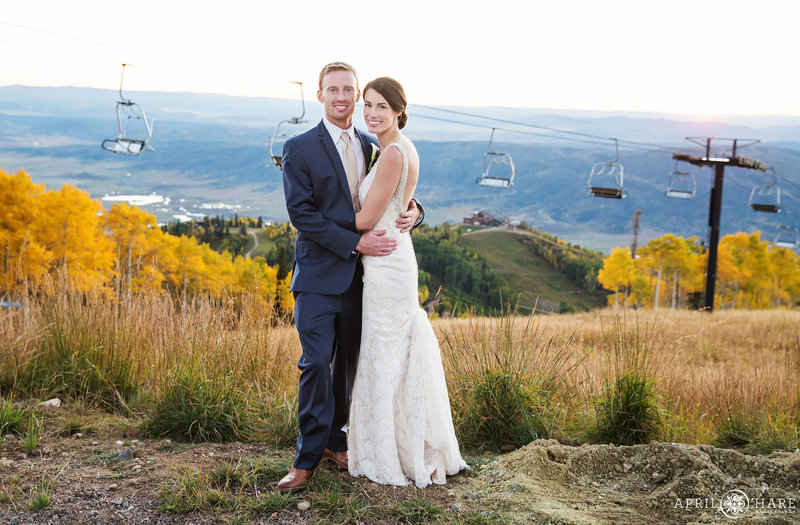 Beautiful fall wedding picture of a bride and groom at Four Points Lodge with the chairlifts in the backdrop