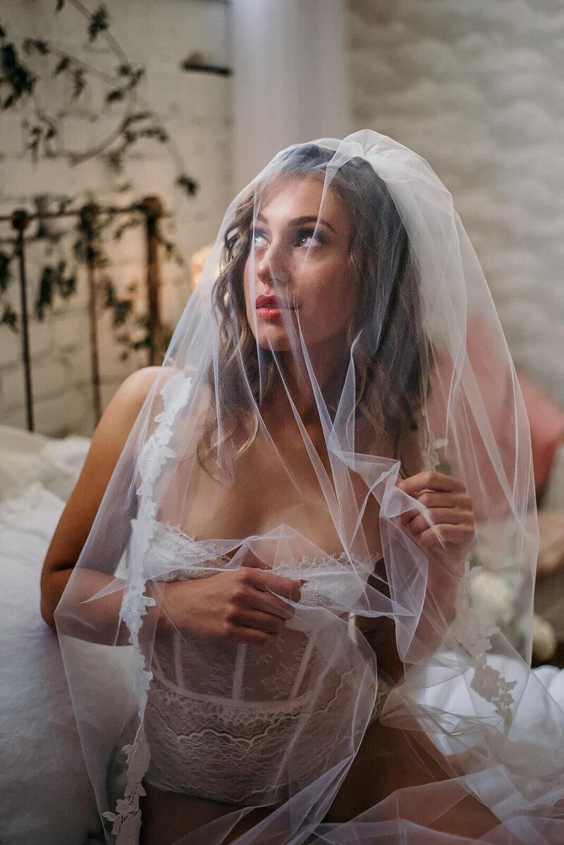 Bride with veil over face at Boudoir Photoshoot in Edmonton, Alberta