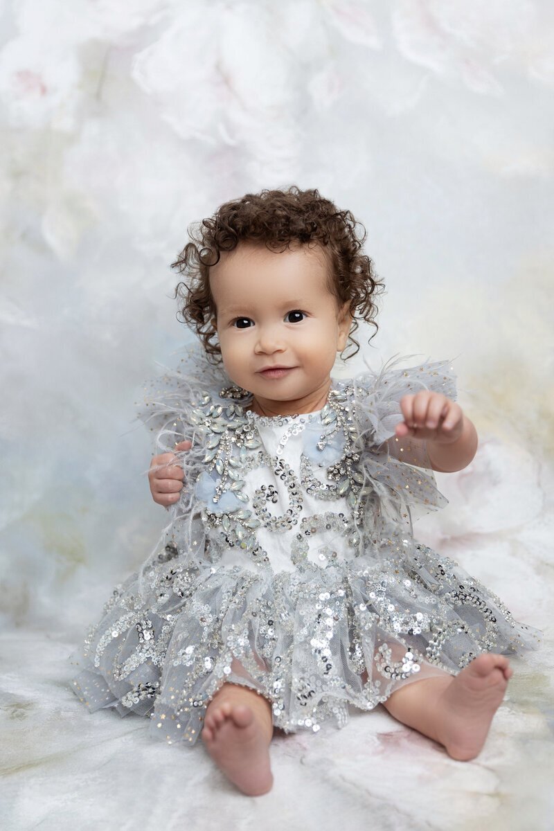 Little girl wearing dress sitting for cake smash photographer nj