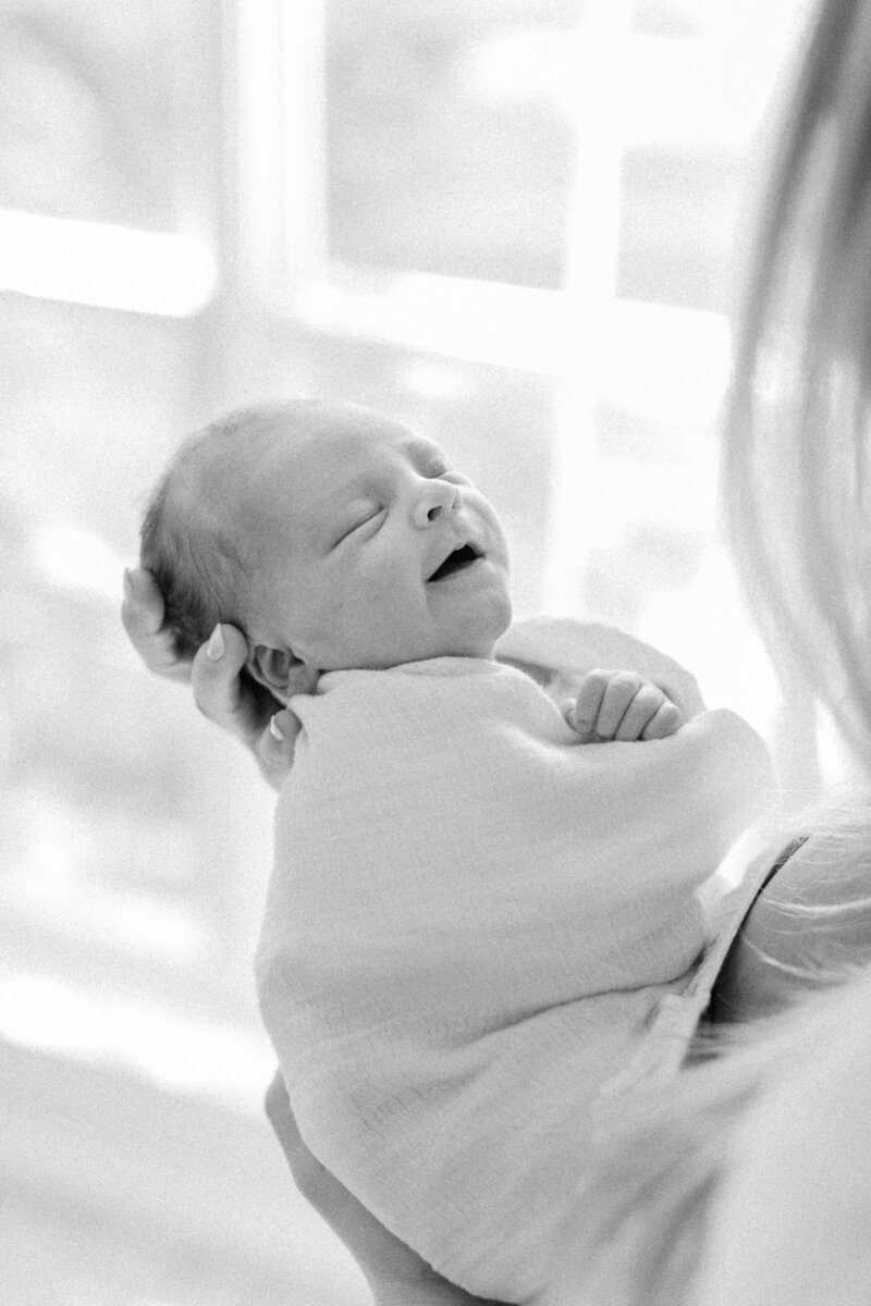 newborn baby smiling by Orlando lifestyle photographer