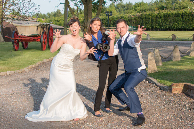 Photographers posing with bride in fun photo