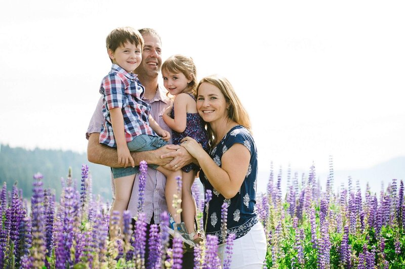 Family portrait at Lake Tahoe in field of Lupines joyful