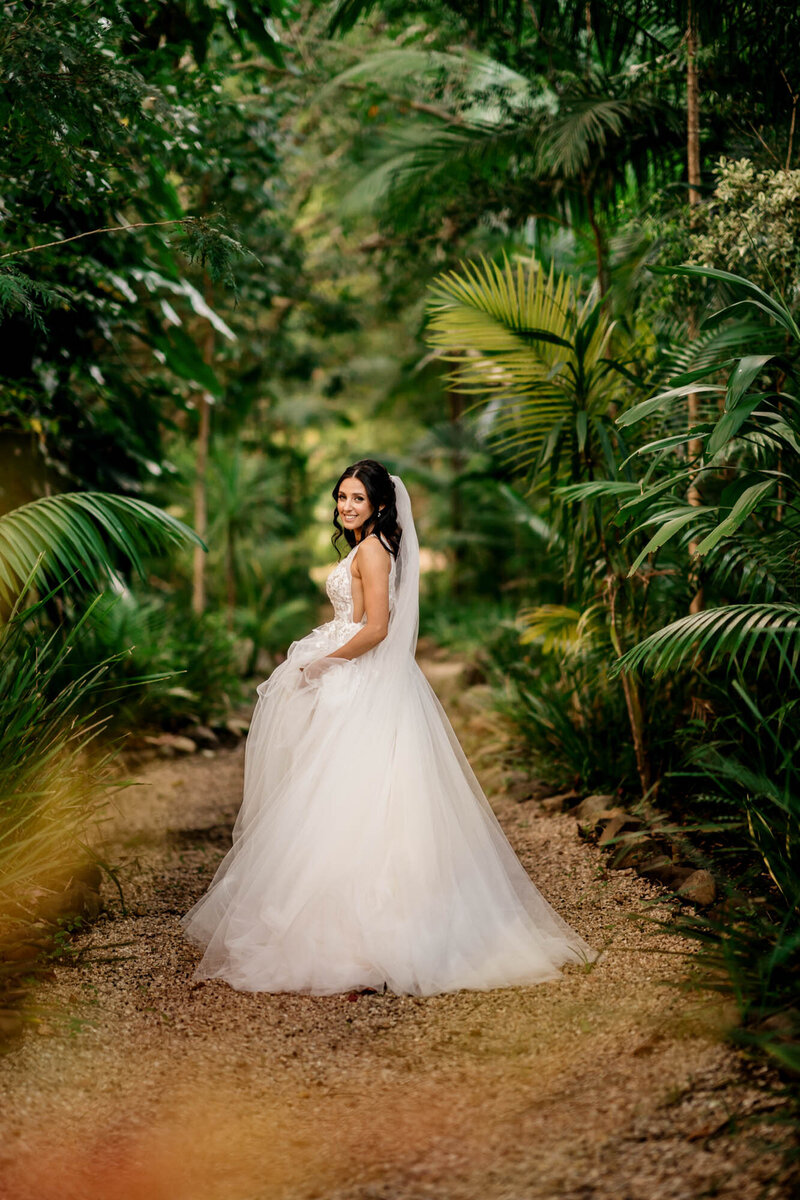 Bride wearing her  beautiful white dress at the green forest
