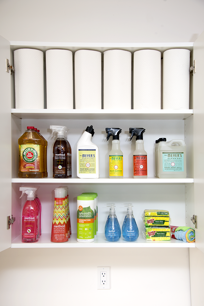 Organized cabinet with paper towels and cleaning products