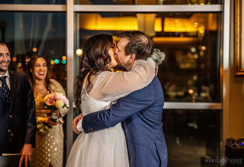 First Kiss Inside Coohills Restaurant at Denver Winter Wedding