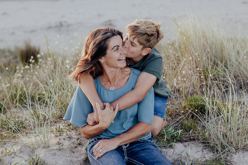 Mum and son enjoying a fun moment on their family photoshoot at Matapouri Beach