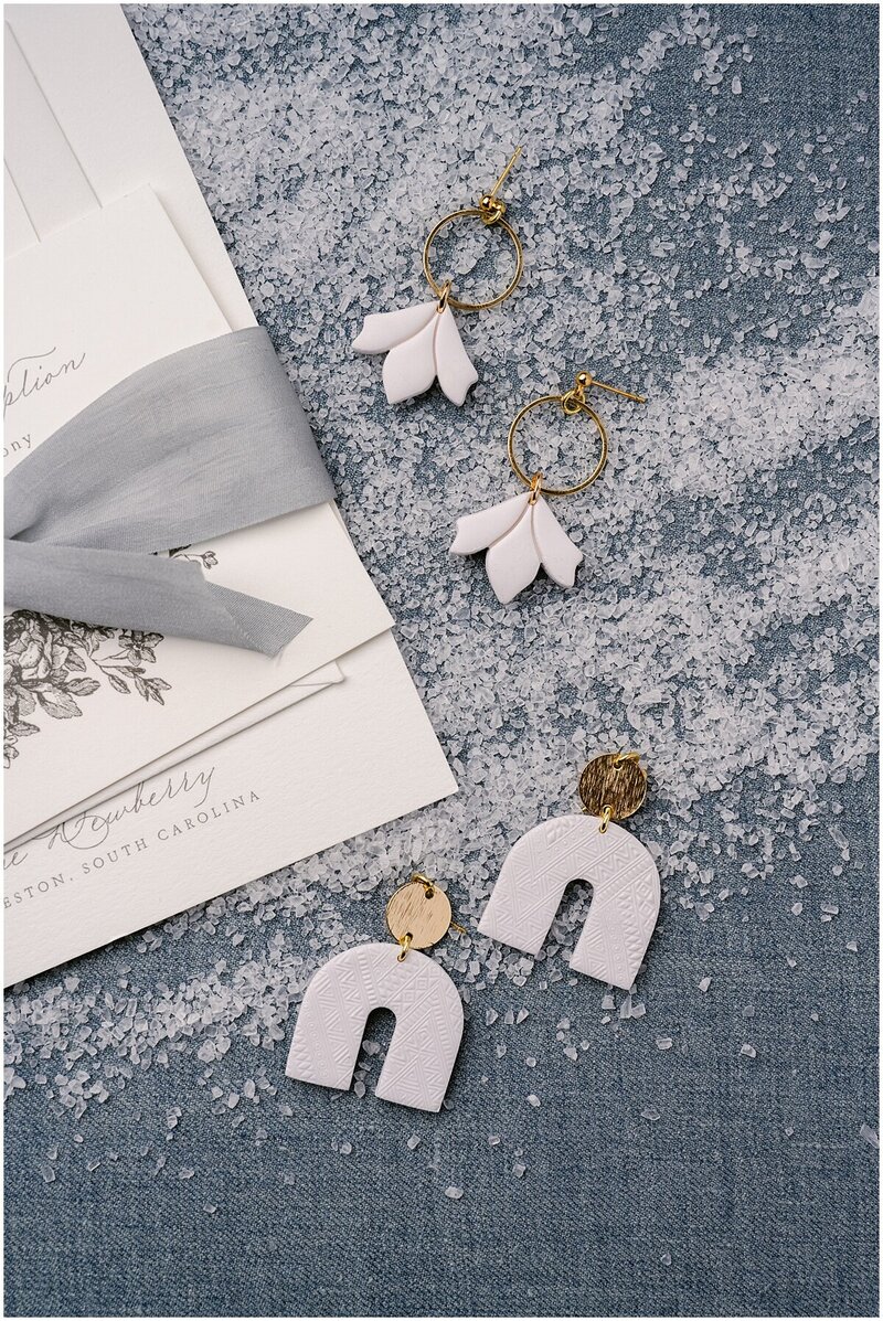 Earrings styled with wedding invitations