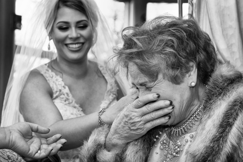 Black and white emotional wedding image of grandmother seeing  her granddaughter  in her wedding dress for the first time. Photo taken by Weddings BY Lee Photography a DC wedding photographer.