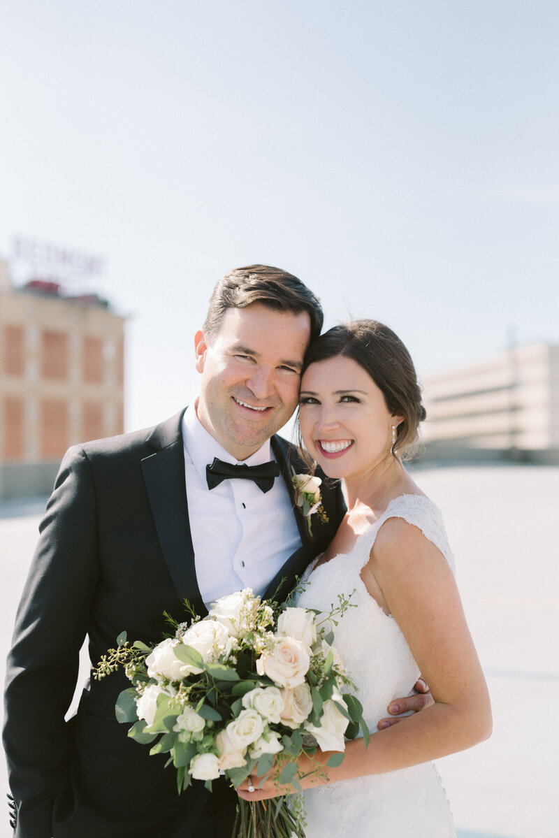 Gorgeous married couple on rooftop behind St Paul's Cathedral in Birmingham, AL