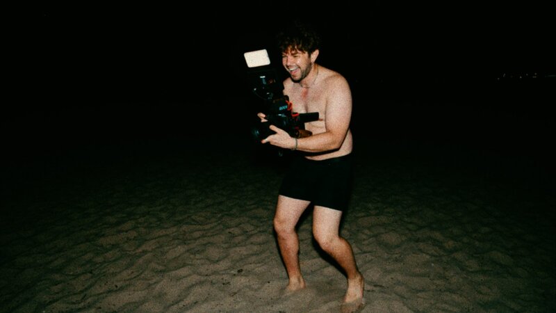 jay filming in his underwear at the beach at night