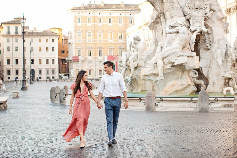 A couple walking in Piazza Navona. Taken by Rome Photographer, Tricia Anne Photography