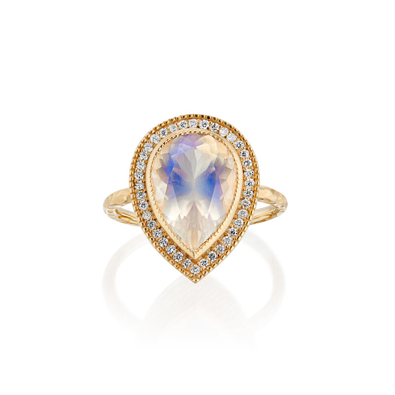 Beautiful blue sheen moonstone in 18k gold setting with full natural diamond halo
