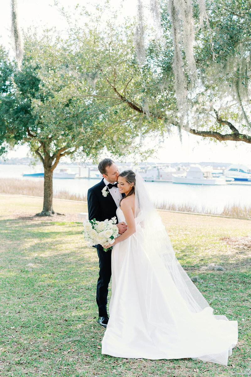 Bride and groom along the marsh on their wedding day at the Savannah Yacht Club