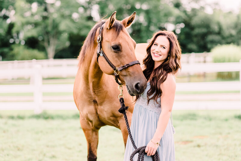 Girl in light blue dress standing next to buckskin horse with long brunette hair by Michigan Equine photographer Stephanie Anne