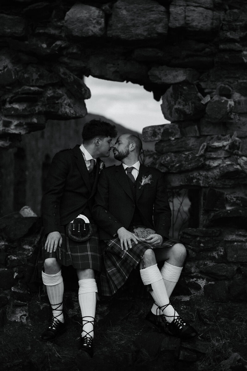 grooms share a kiss