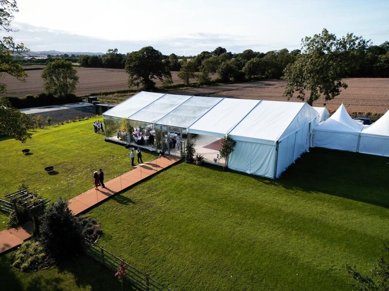 A large frame marquee with 60% of it having a clear roof.