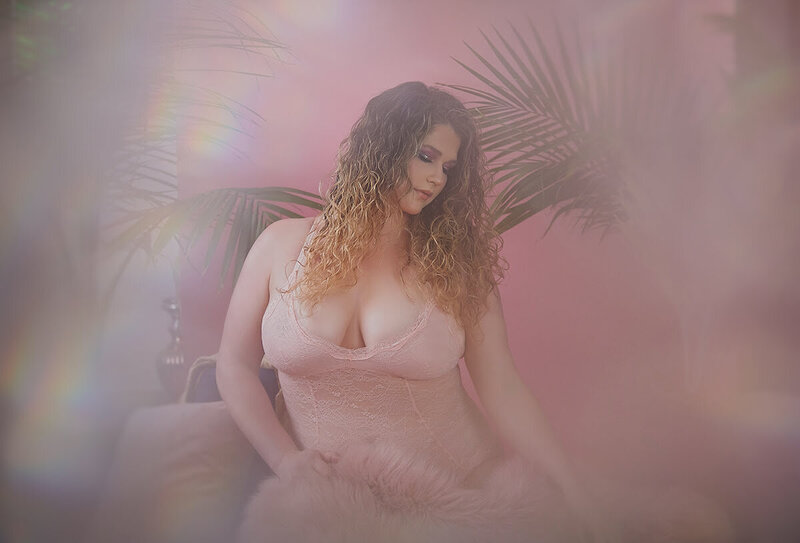 Woman wearing pink lingerie with tropical background