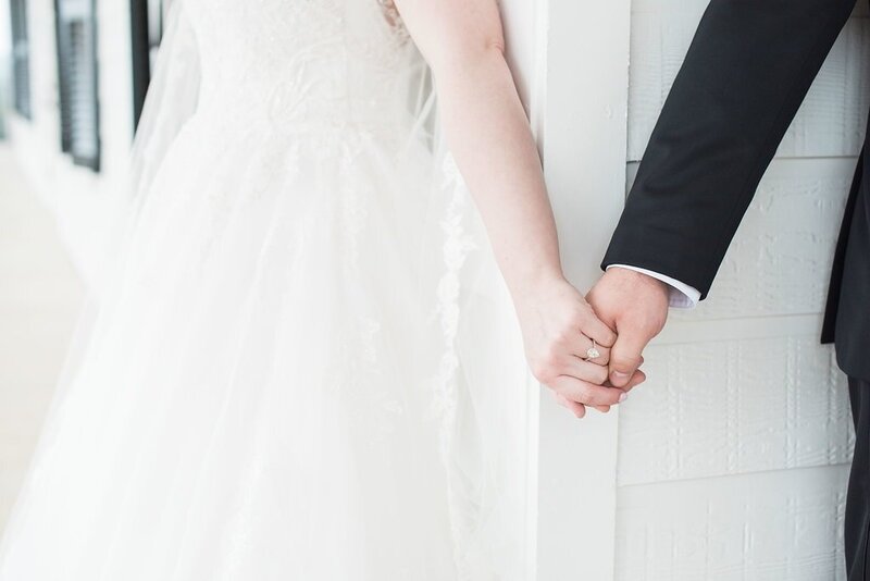 Bride and groom hold hands before wedding ceremony