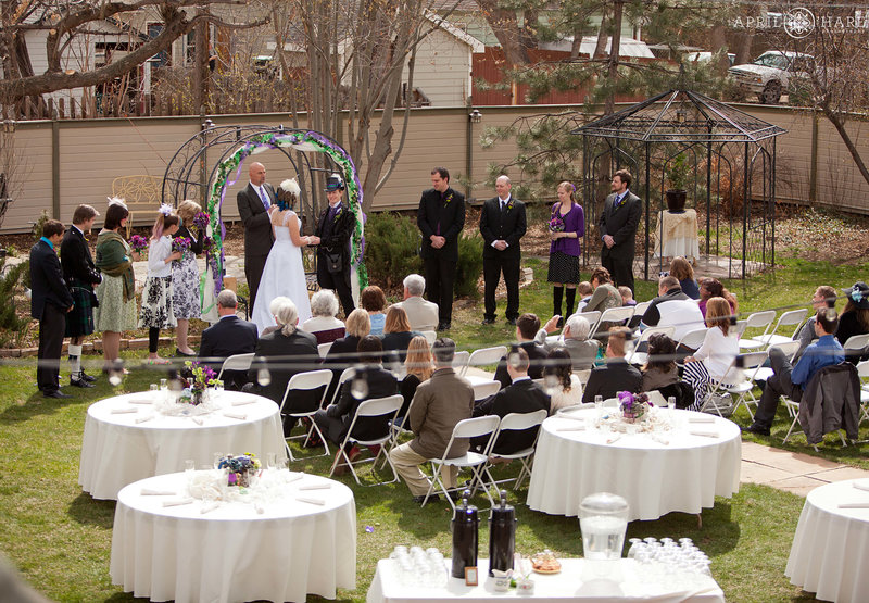 Wedding ceremony in the backyard of McCreery House wedding venue with tables set up in Loveland Colorado