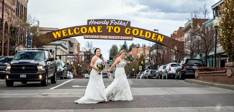 Brides under the historic Welcome to Golden Arch at The Golden Hotel in Colorado