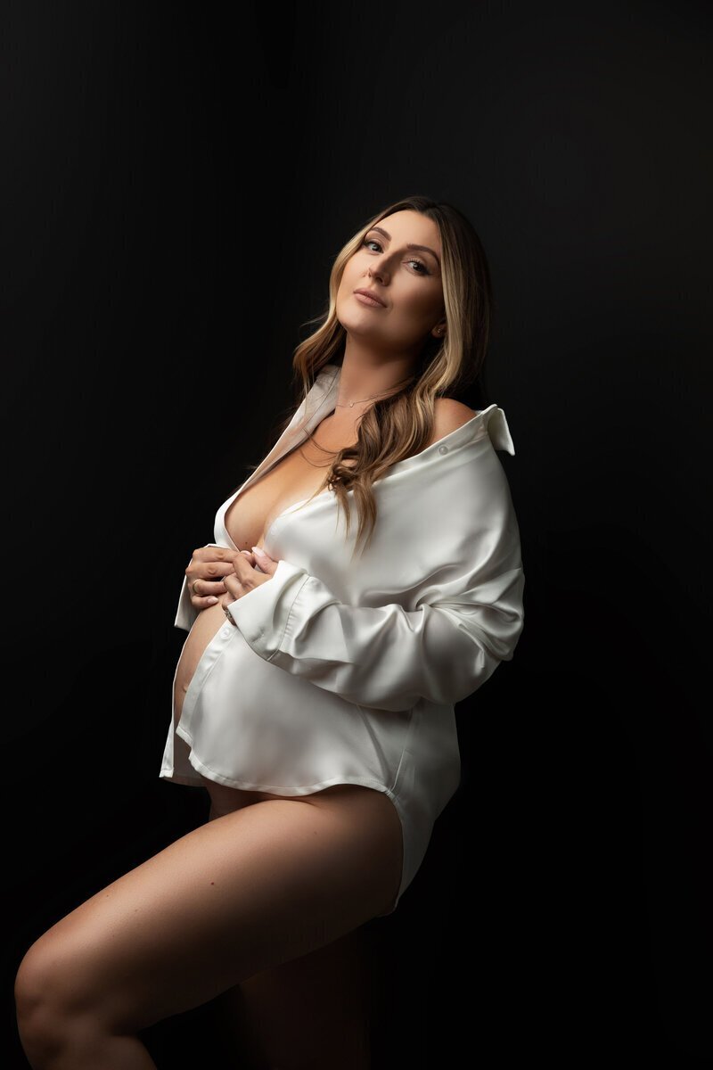 Expecting mom wearing white silk, taken by maternity photographer new jersey
