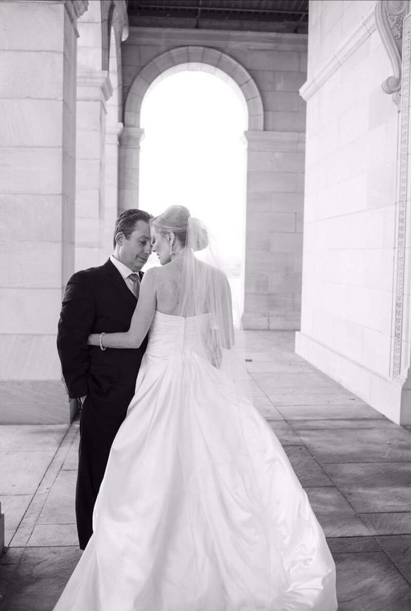Black and white photo of bride and groom kissing each other