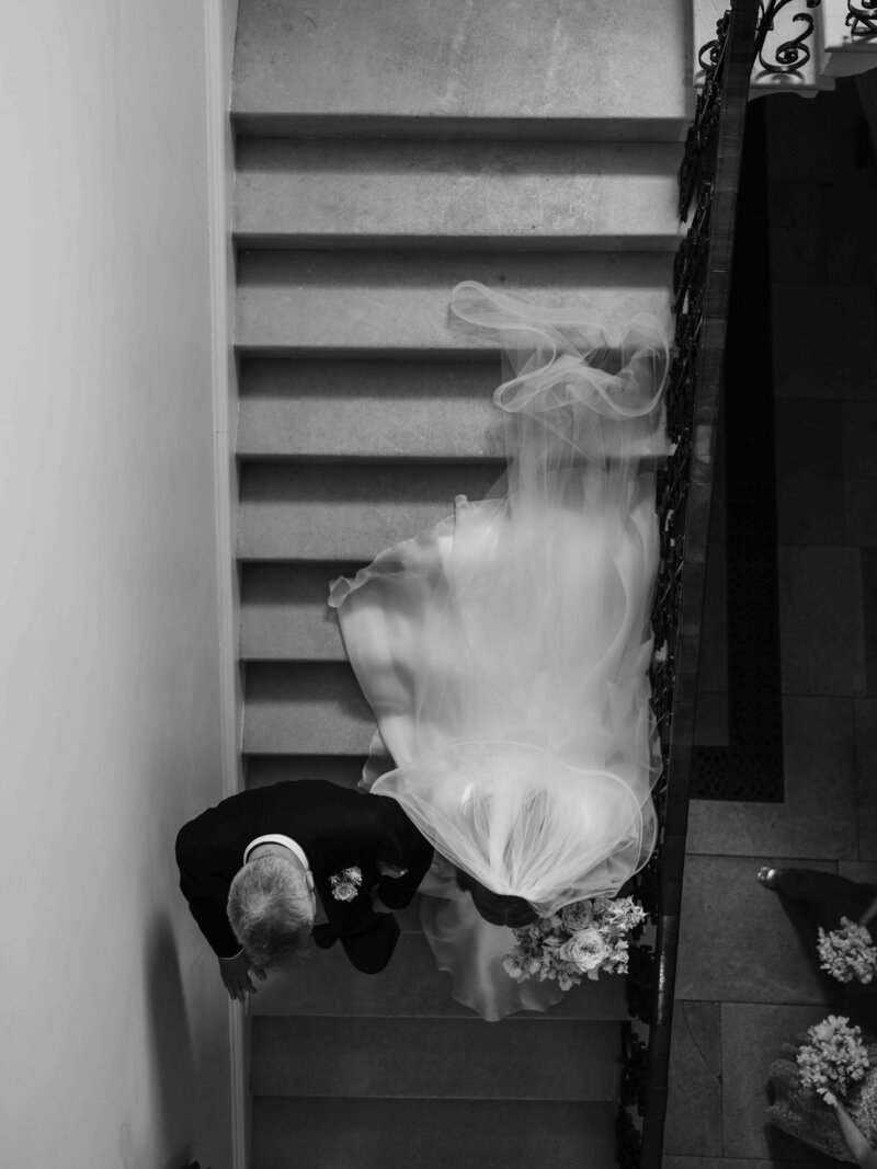 Bride and her father walking down the stairs