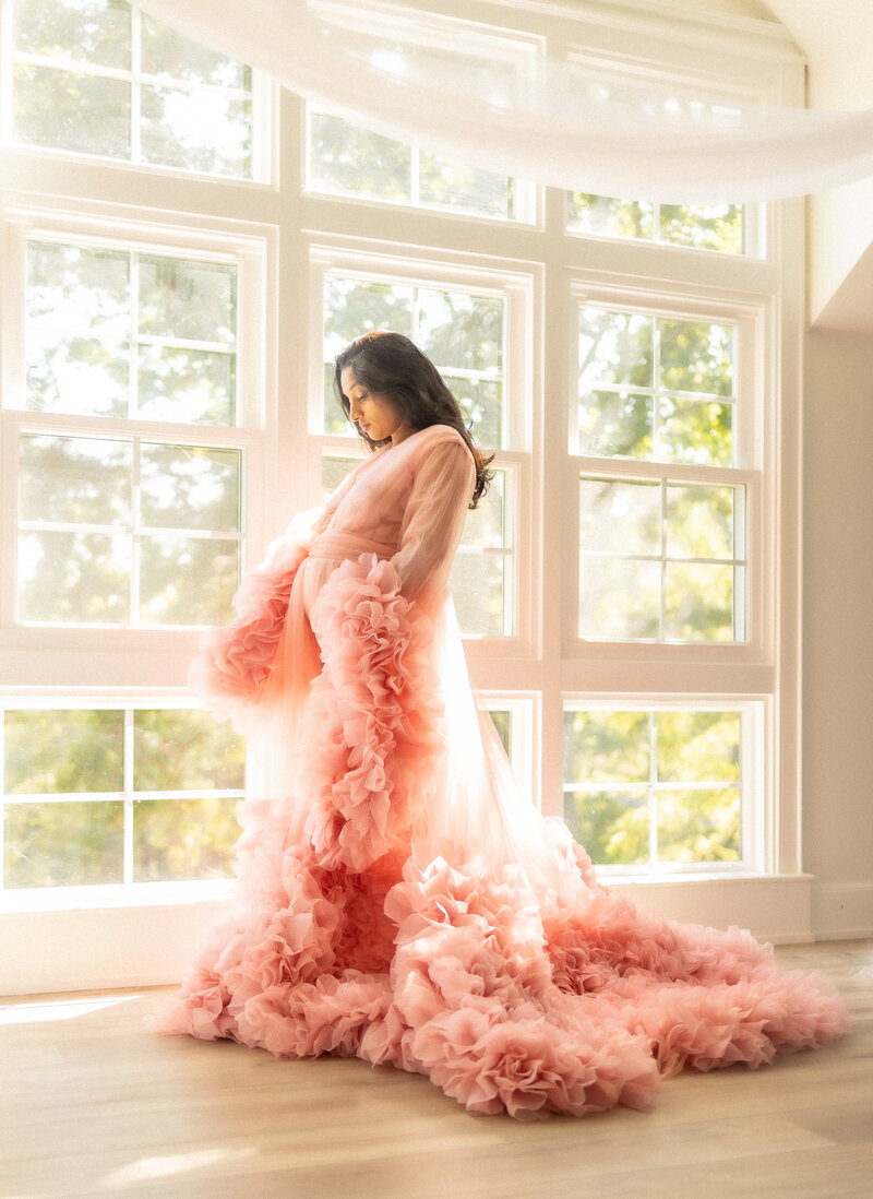 Model with pink robe in a window, Maryland maternity photographer
