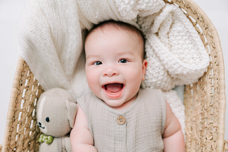 6 Month old baby boy capturing a smile in the studio of molly berry photography