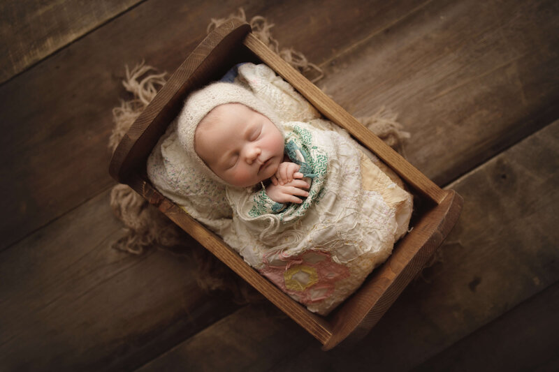 newborn baby girl sleeping with wood background