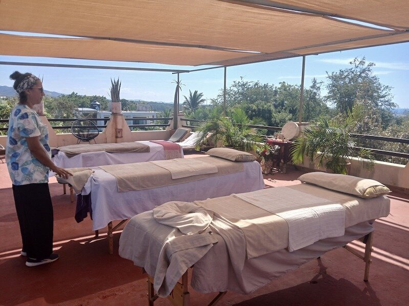 The wellness space at Tanana Holístico offering therapies such as relaxing massages, deep facial cleansing, cupping, and body wraps, along with handcrafted products like sandals, beach bags, and swimwear — all designed to promote harmony between body and spirit.