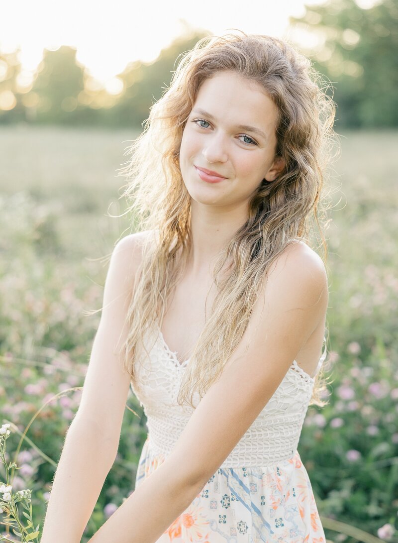 senior girl smiling with in a field of flowers, Indianapolis senior photographer