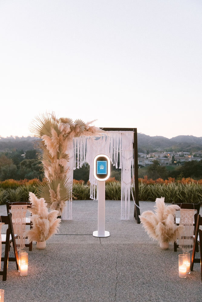 Photo booth set up in front of BoHo arbor for a Seattle wedding