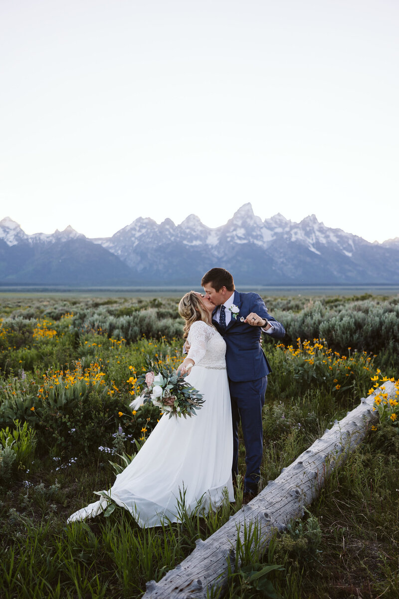 A couple kissing in front of the Tetons in Jackson Wyoming