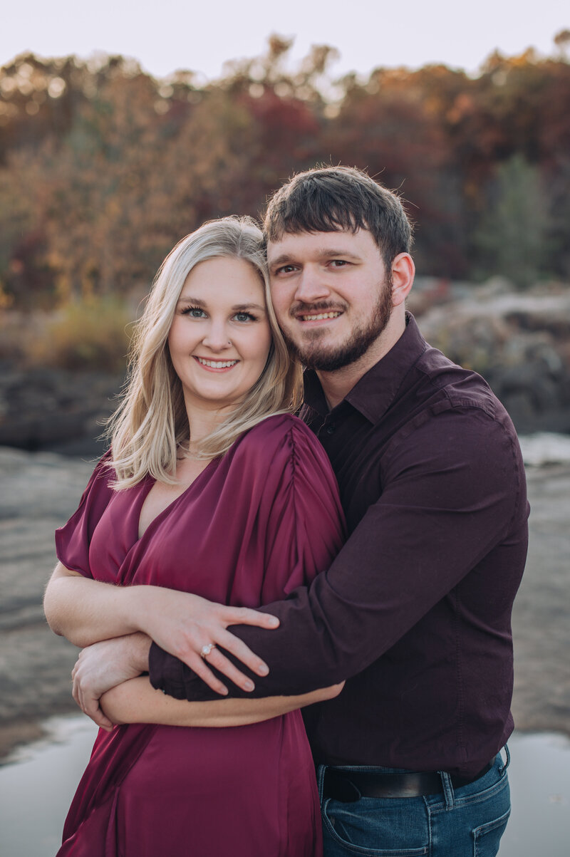 a couple smiling at the camera for engagement photos