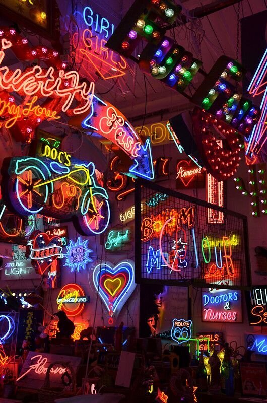 place full of neon signs, with different colors, shapes and sizes.