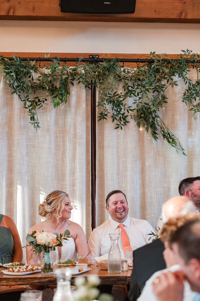 bride and groom sharing laughter during wedding ceremony at barnwood events in madison, winconsin.