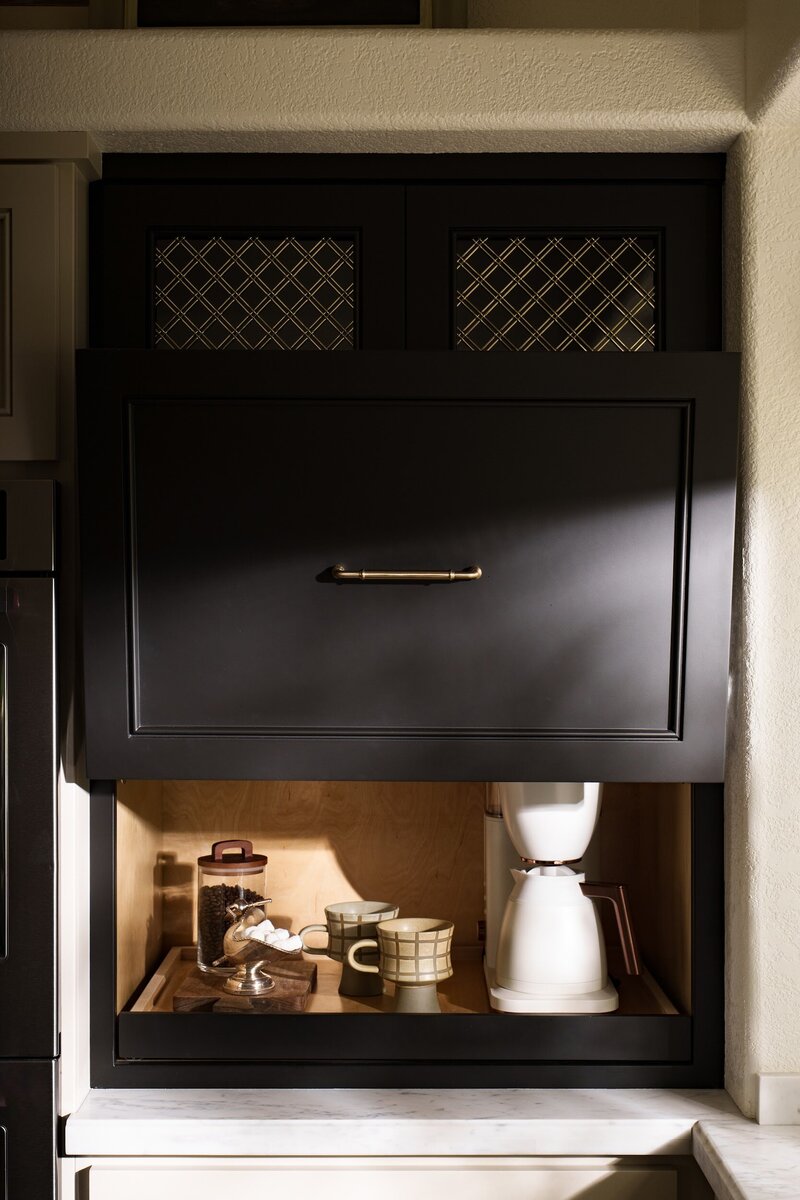 black paitned shaker appliance garage wiht brass hardware and brass mesh detail.