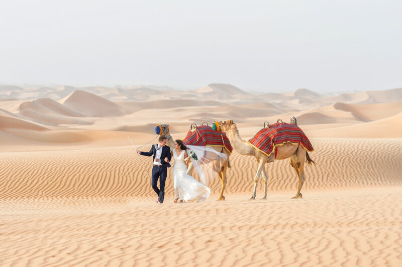 Dubai wedding photoshoot amidst desert dunes with camels organized by Lovely & Planned