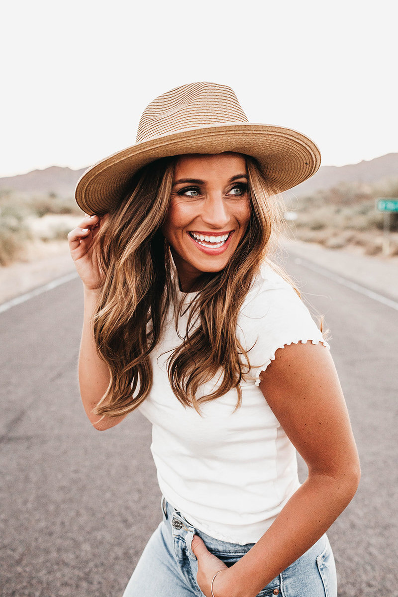 woman wearing hat and smiling