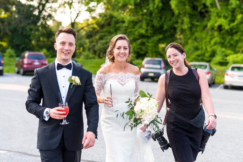 wedding photographer, Allison McCafferty, walking with a bride and groom