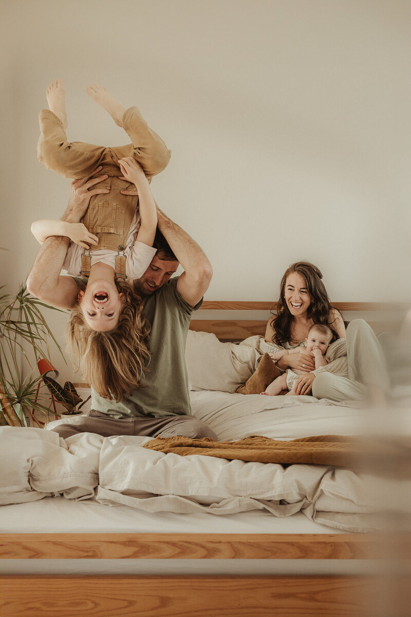 family jumping on sofa breast feeding motherhood new mummy